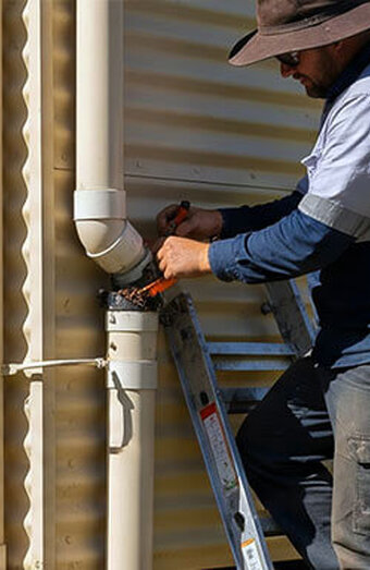 Plumber Clearing Downpipe